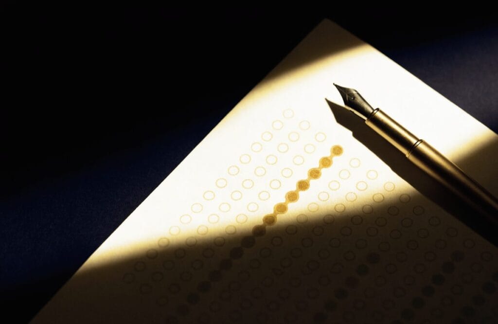 A CLAT-style answer sheet with rows of answer bubbles and a gold pen, one row part-filled, lit against a dark navy background.